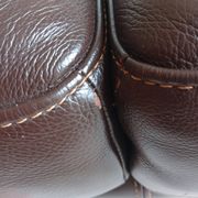 Two brown leather Crozatier two-and-a-half-seater sofas.