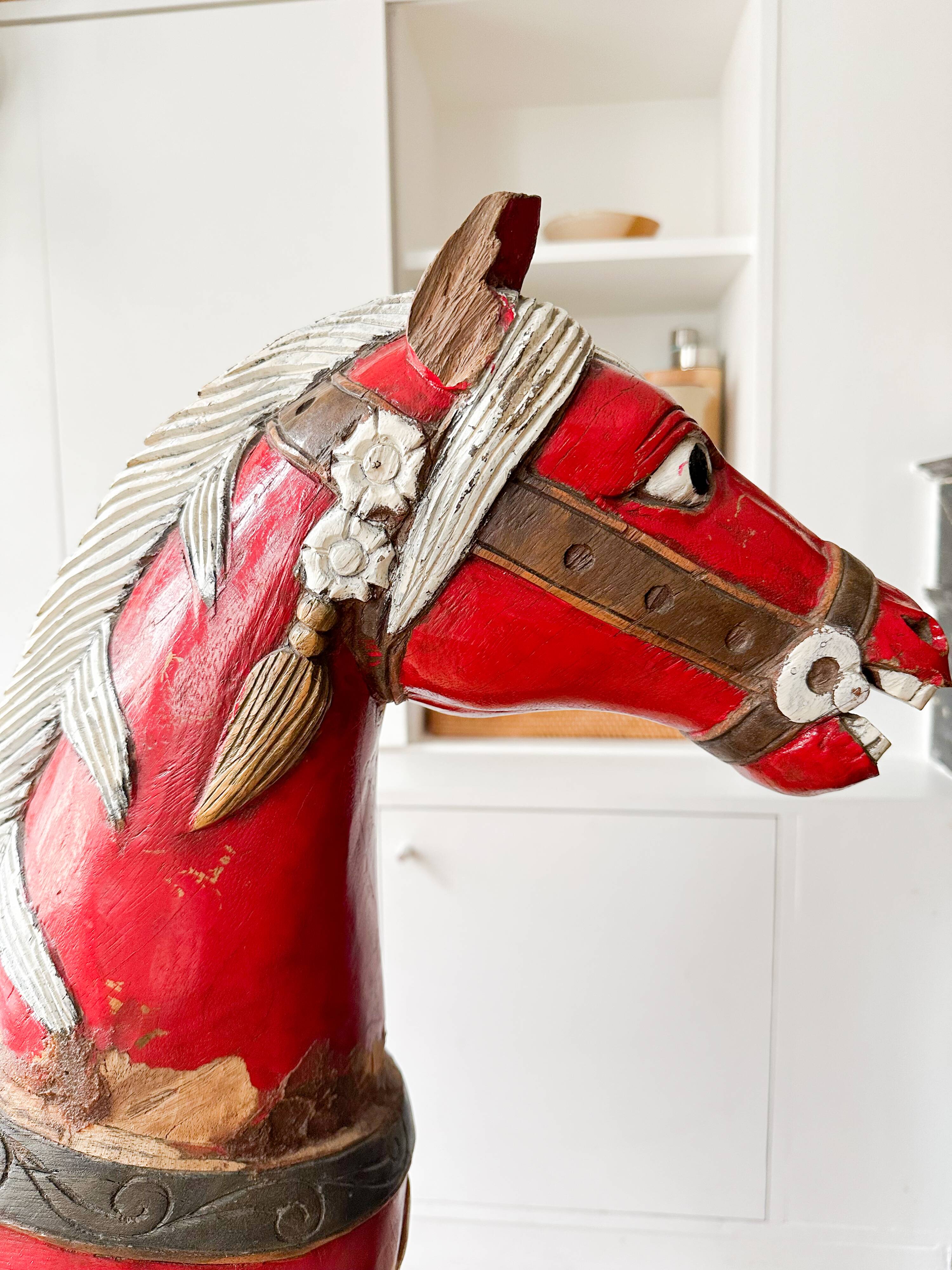 Large decorative rocking horse made of carved and hand-painted wood.