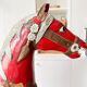 Large decorative rocking horse made of carved and hand-painted wood.
