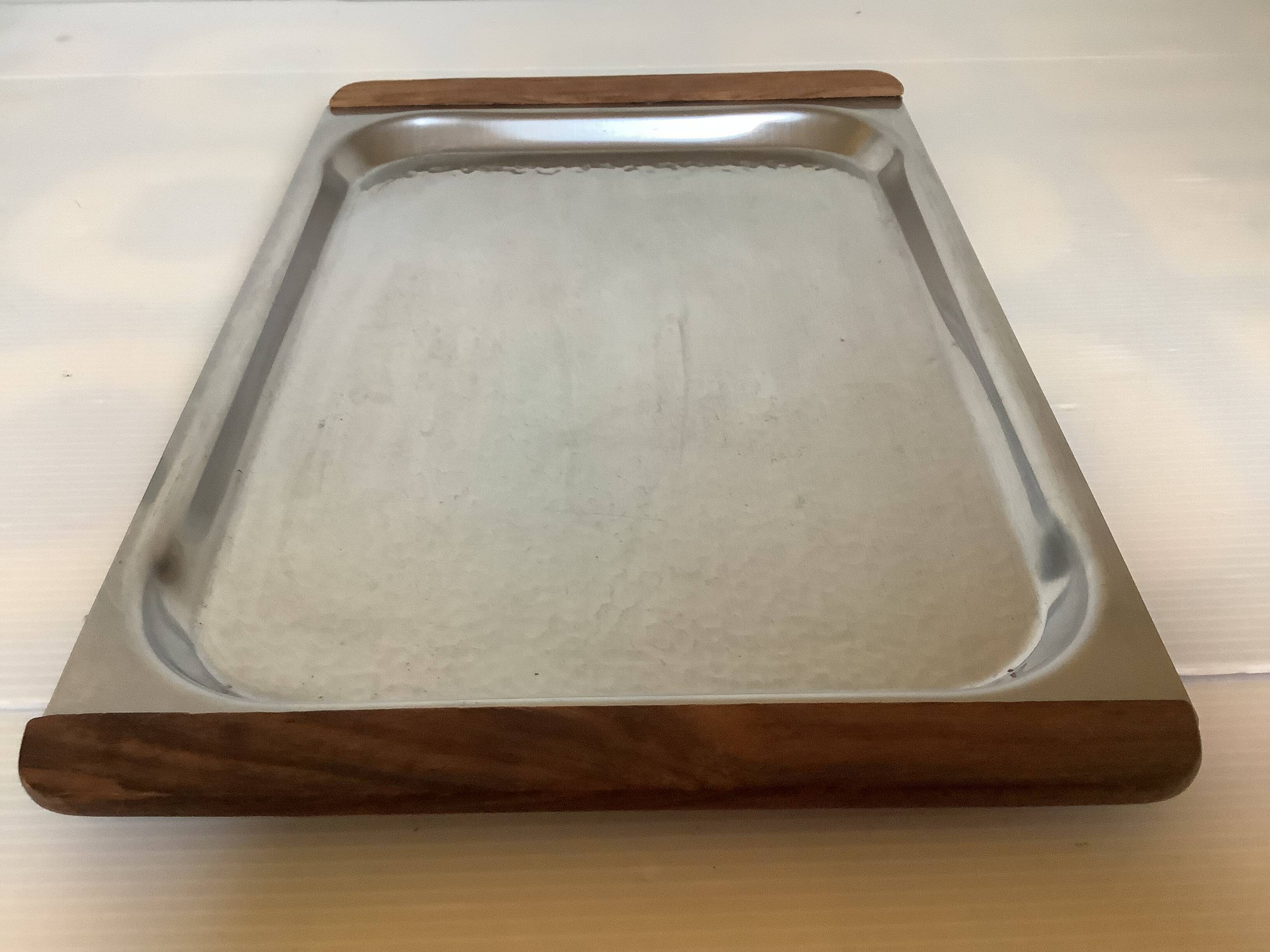 Small hammered metal and wood tray in Scandinavian style.