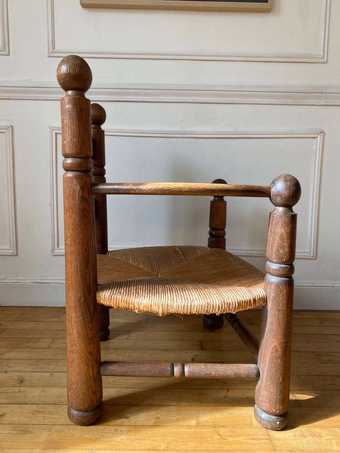 Straw and turned wood fireplace armchair in the style of Charles Dudouyt