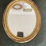 Oval mirror in gilded wood.