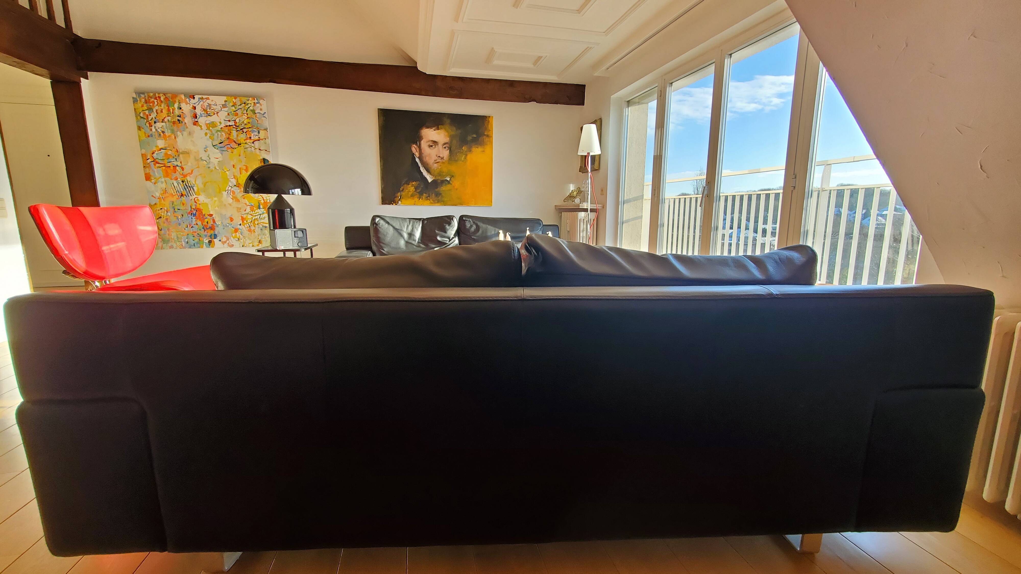 Black leather three-seater sofa