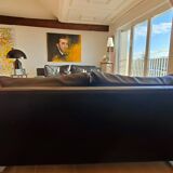 Black leather three-seater sofa