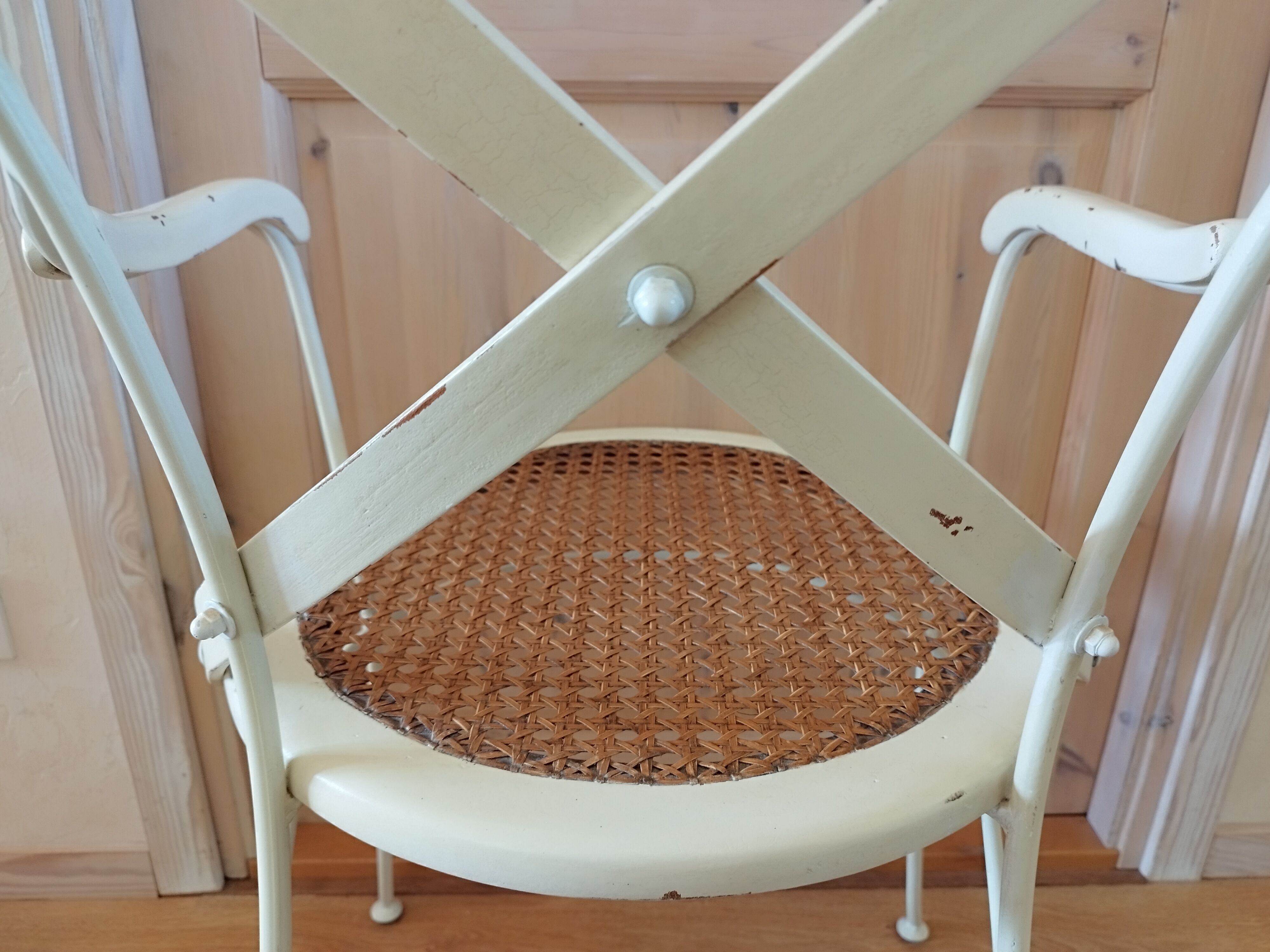 Canned chair with wooden and metal braces