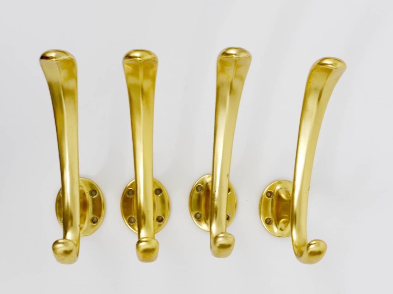 Set of four mid-century golden wall hooks, Austria, Vienna, 1950s.
