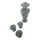 Carafe of green-striped liquor and its three glasses