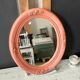 Oval terracotta mirror with pink shapes in resin