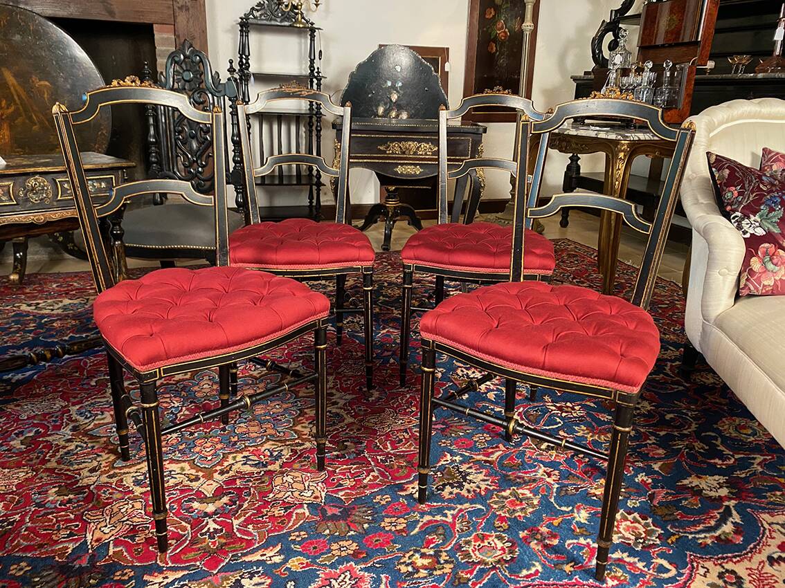 Set of four Napoleon III chairs in black lacquered wood with gold highlights.