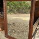 Large wall mirror with an elegant wooden frame.