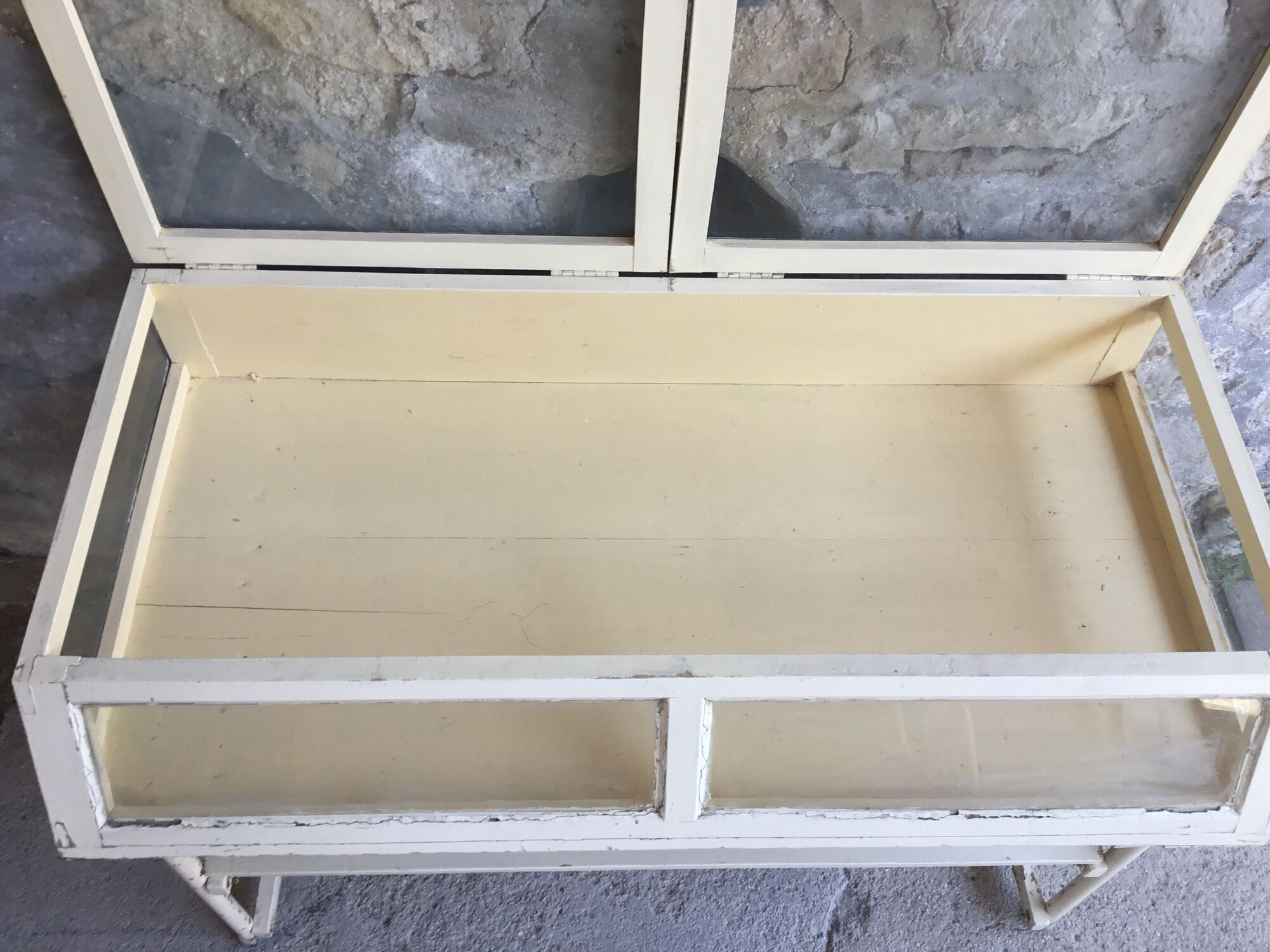 Old showcase on tubular metal feet - early twentieth century