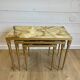 Set of 3 vintage nesting tables in onyx and gold metal from the 1970s.