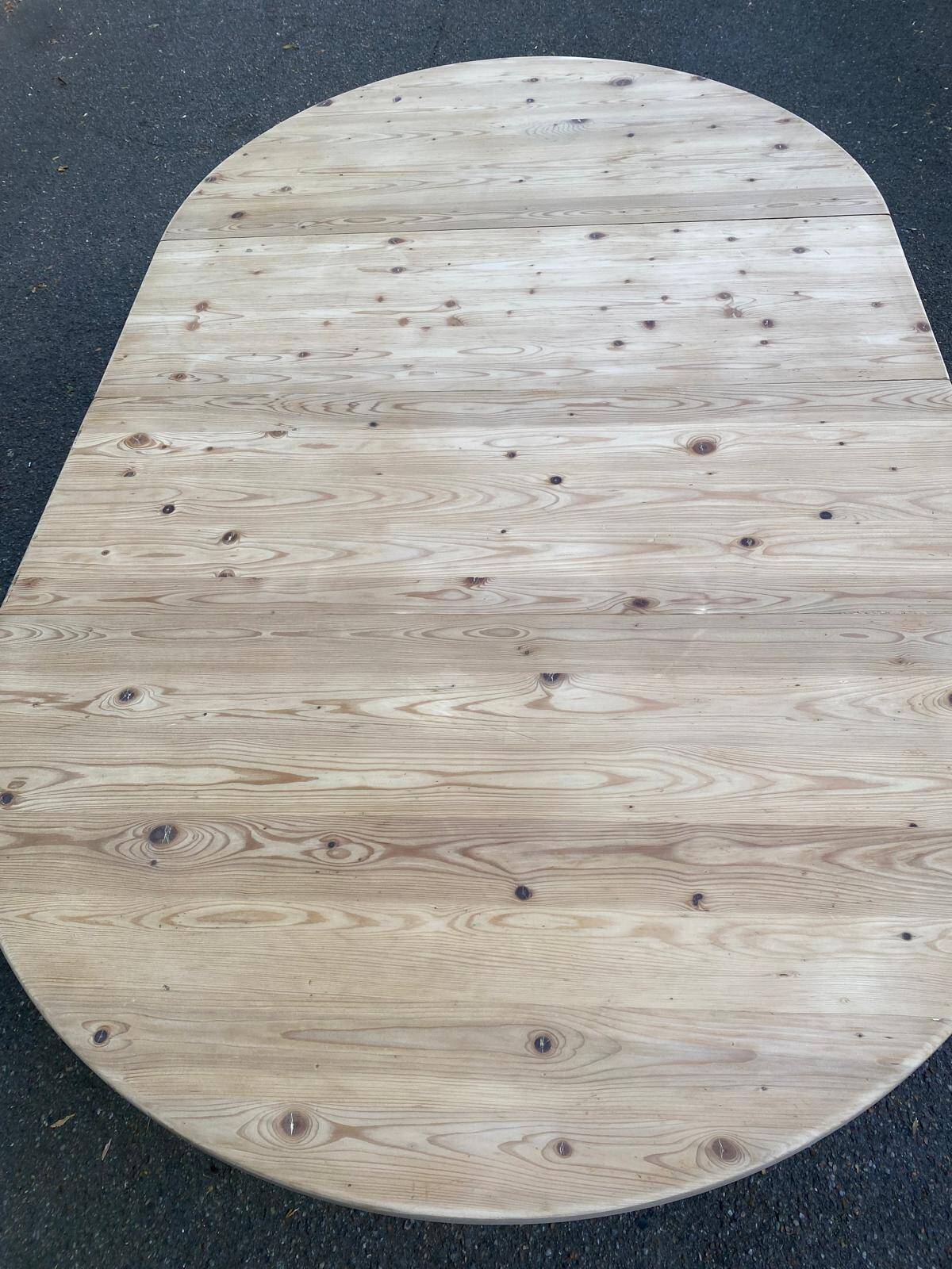 Scandinavian round extendable dining table stripped in solid wood from the 1970s.