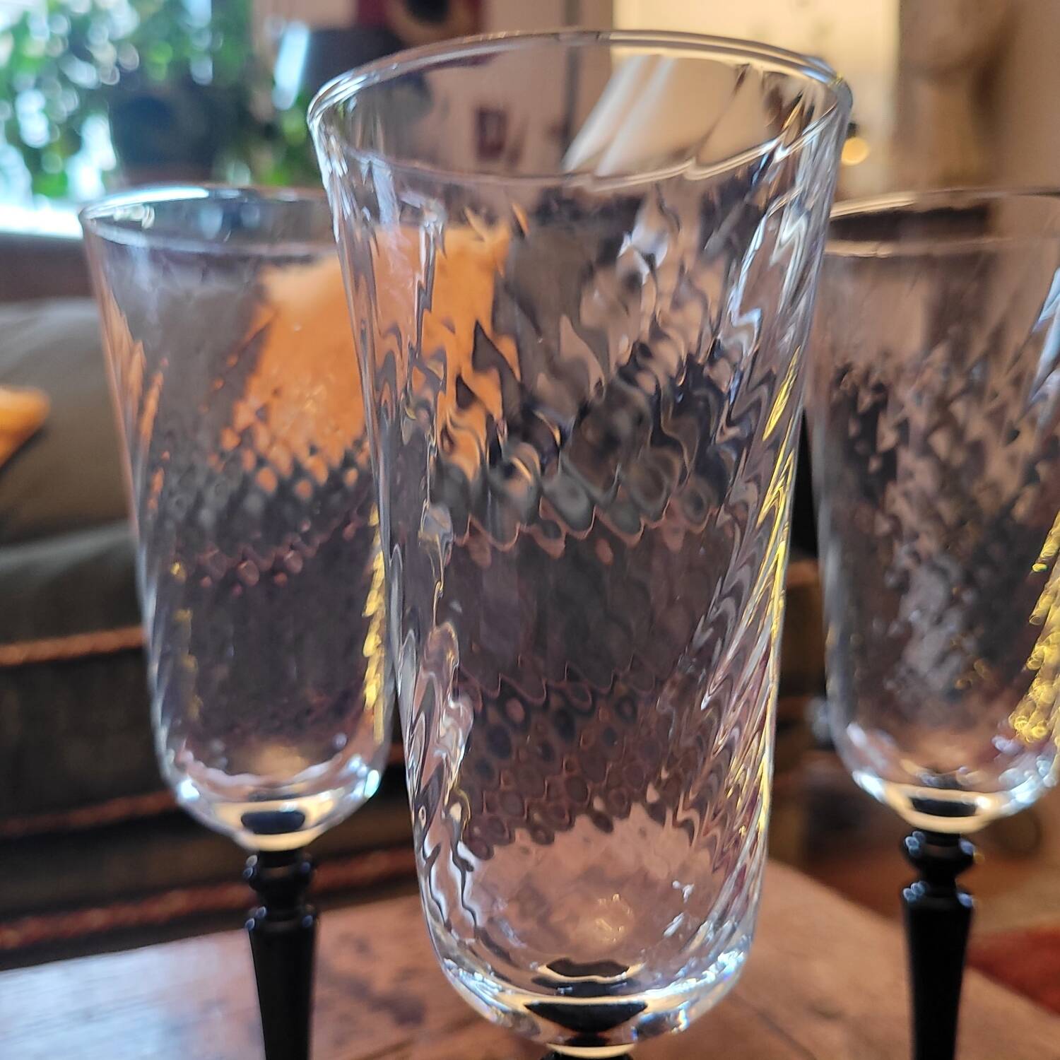 4 clear glass flutes with black stems. 1960–1970. 4 clear glass flutes with black stems.