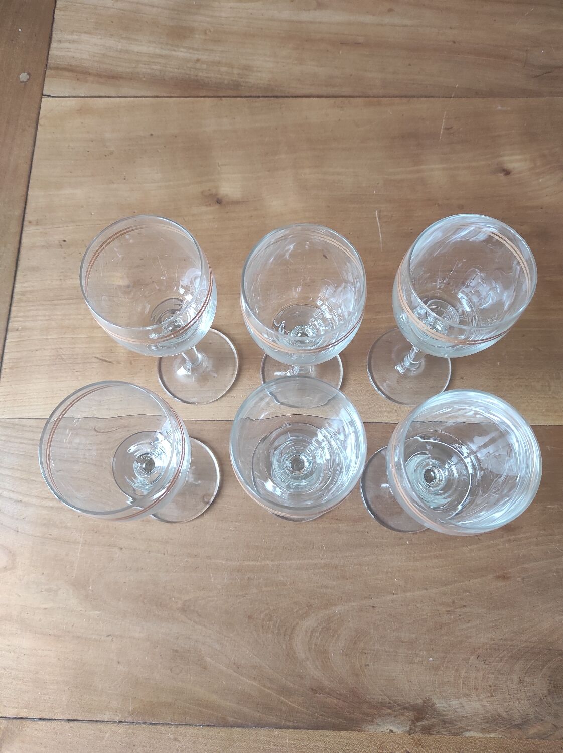Set of 6 glasses with gold band decorations.