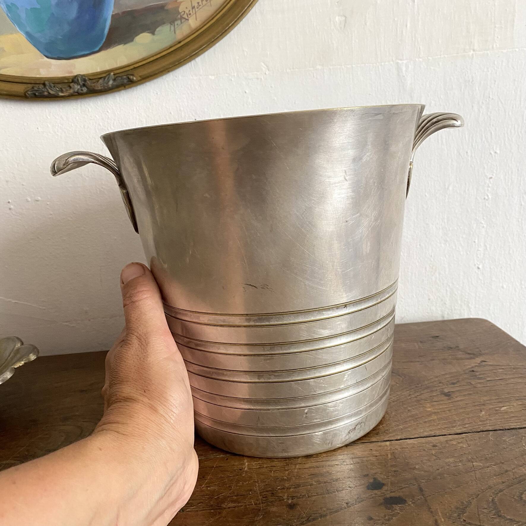 Antique champagne bucket with shell handles.