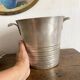 Antique champagne bucket with shell handles.