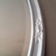 Vintage white oval mirror in resin.