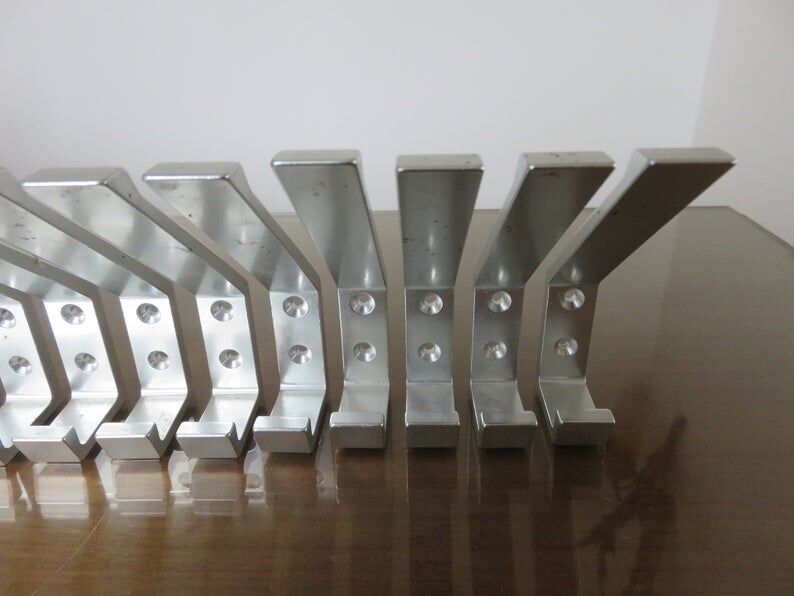 Series of 16 70s aluminium pads