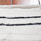 Simple carpet in ecru recycled cotton with black stripes of Berber type