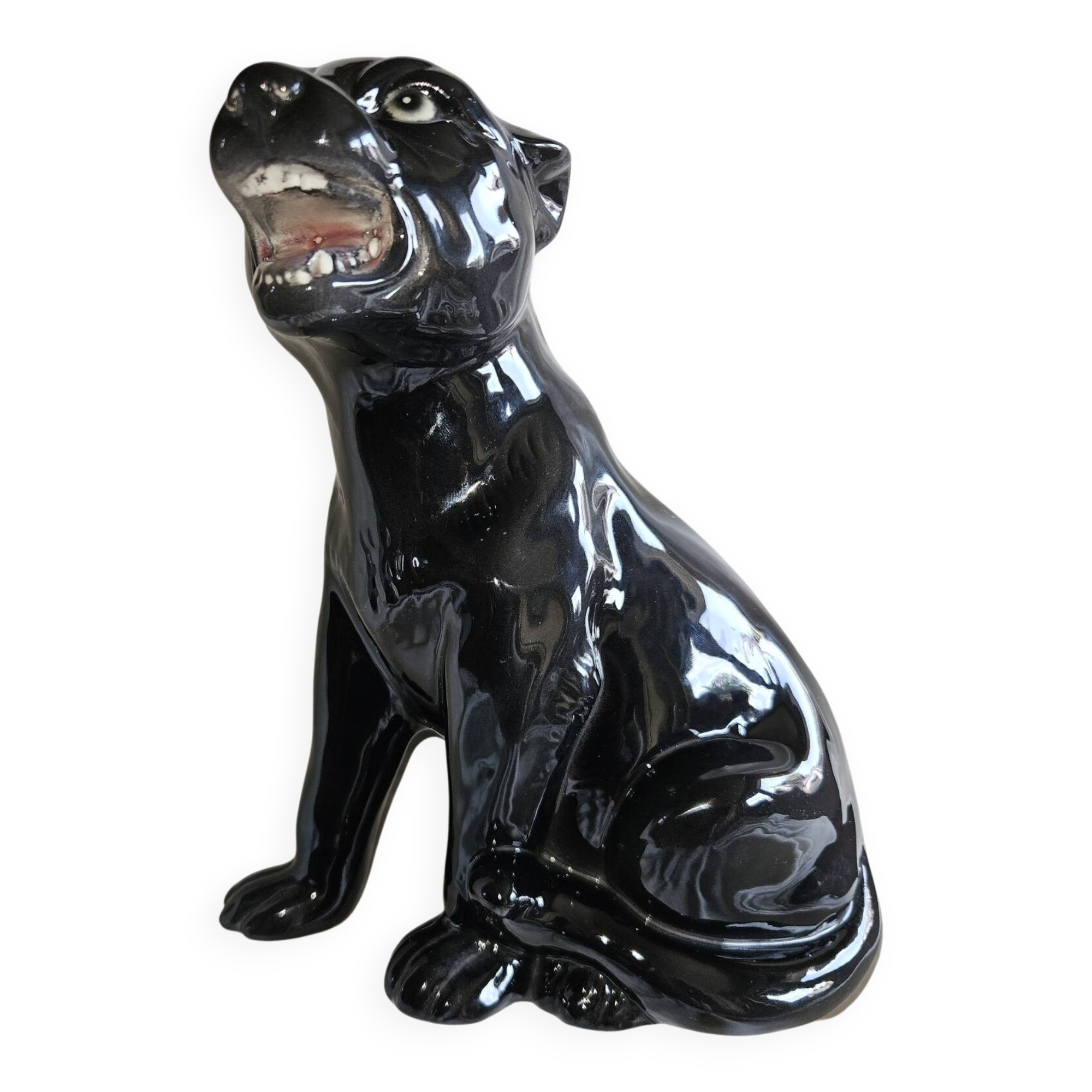 Statue of a roaring panther/leopard sitting in black glazed ceramic.
