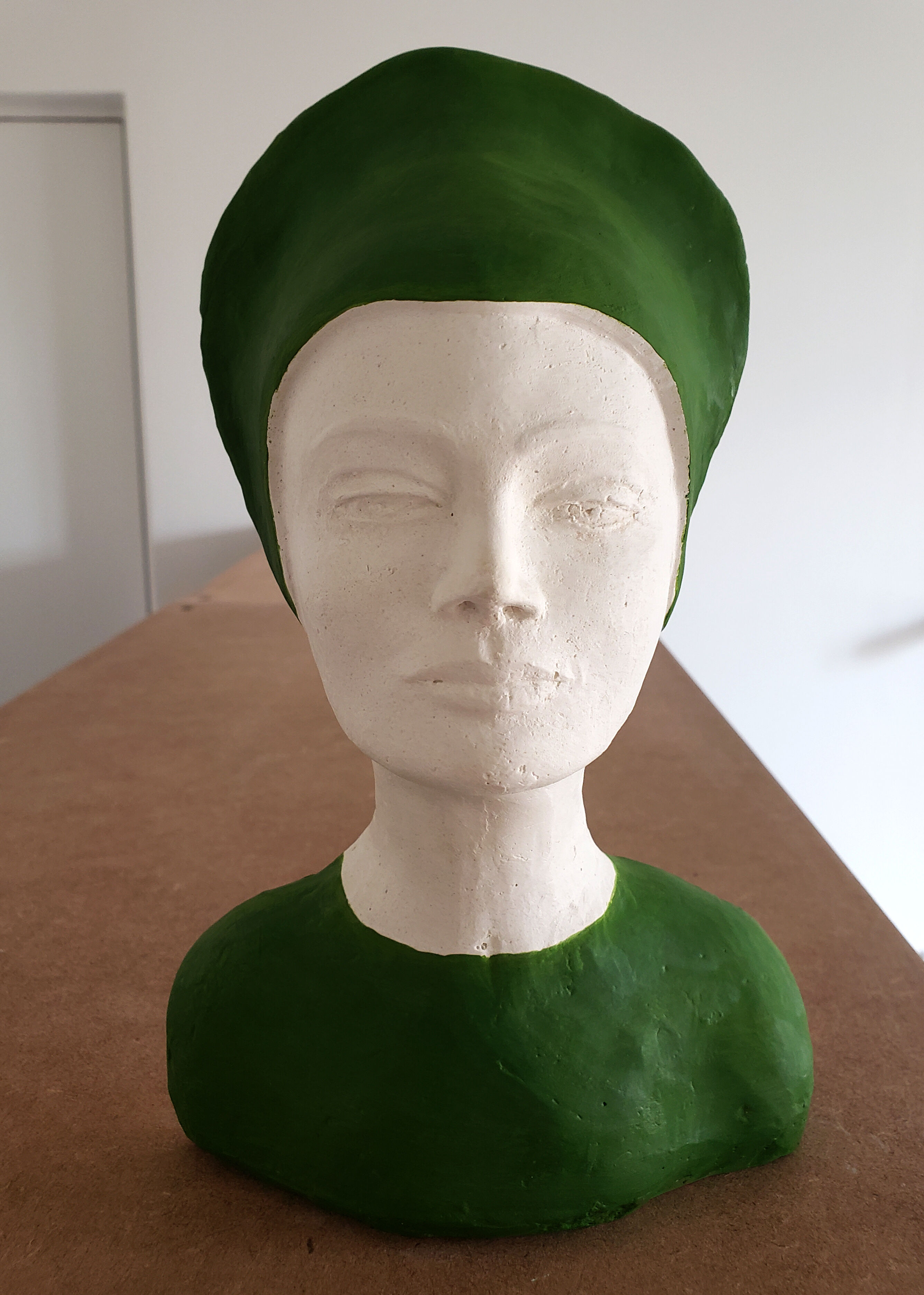 Bust of a woman in green and white plaster