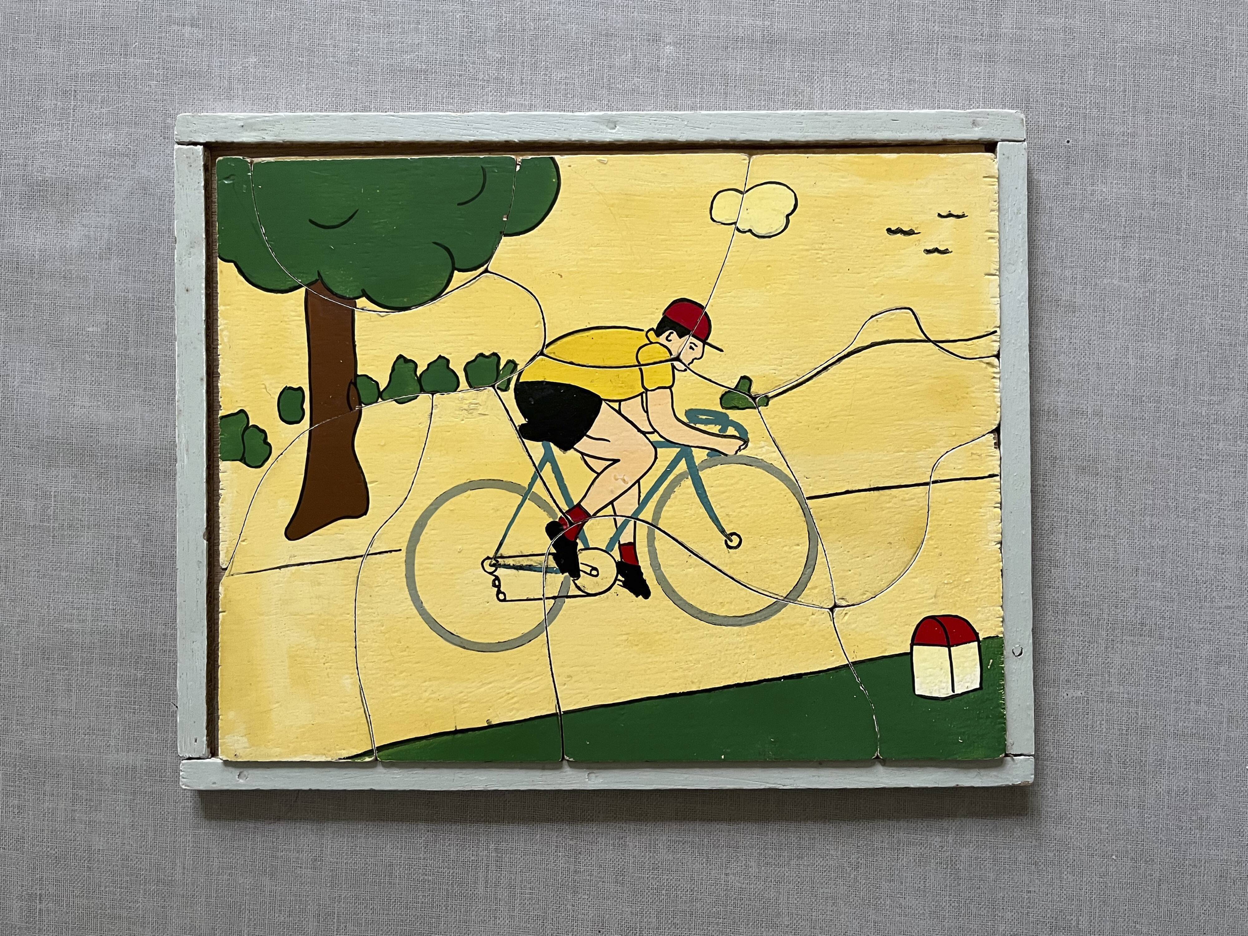 Wooden puzzle frame from the 30s/40s depicting a cyclist