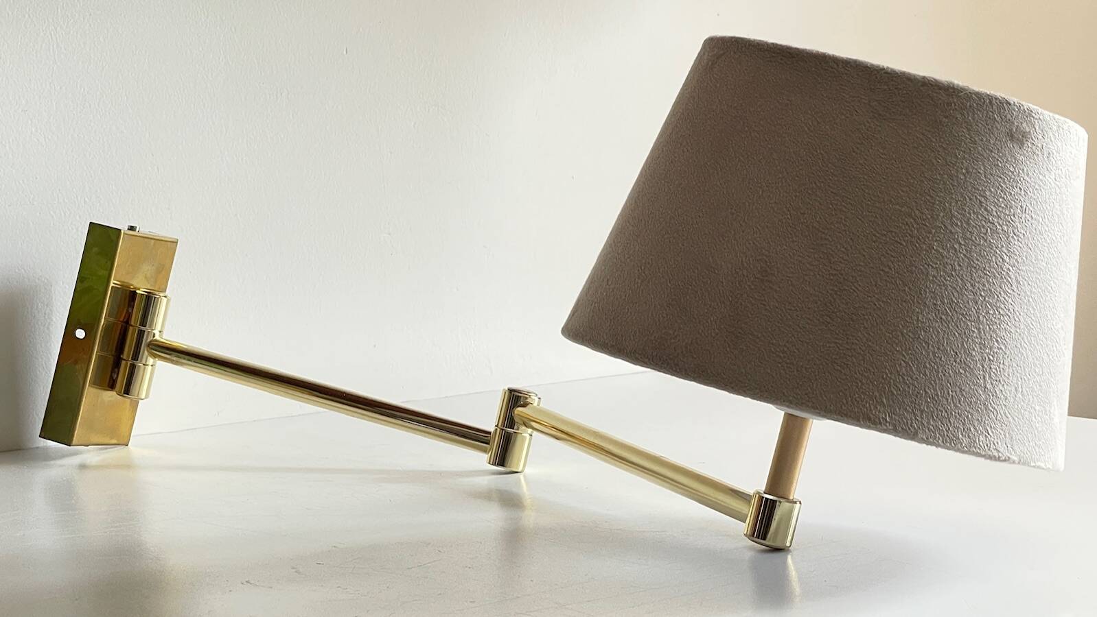articulated brass and velvet wall light