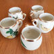 5 antique cups with liquor, porcelain fruits