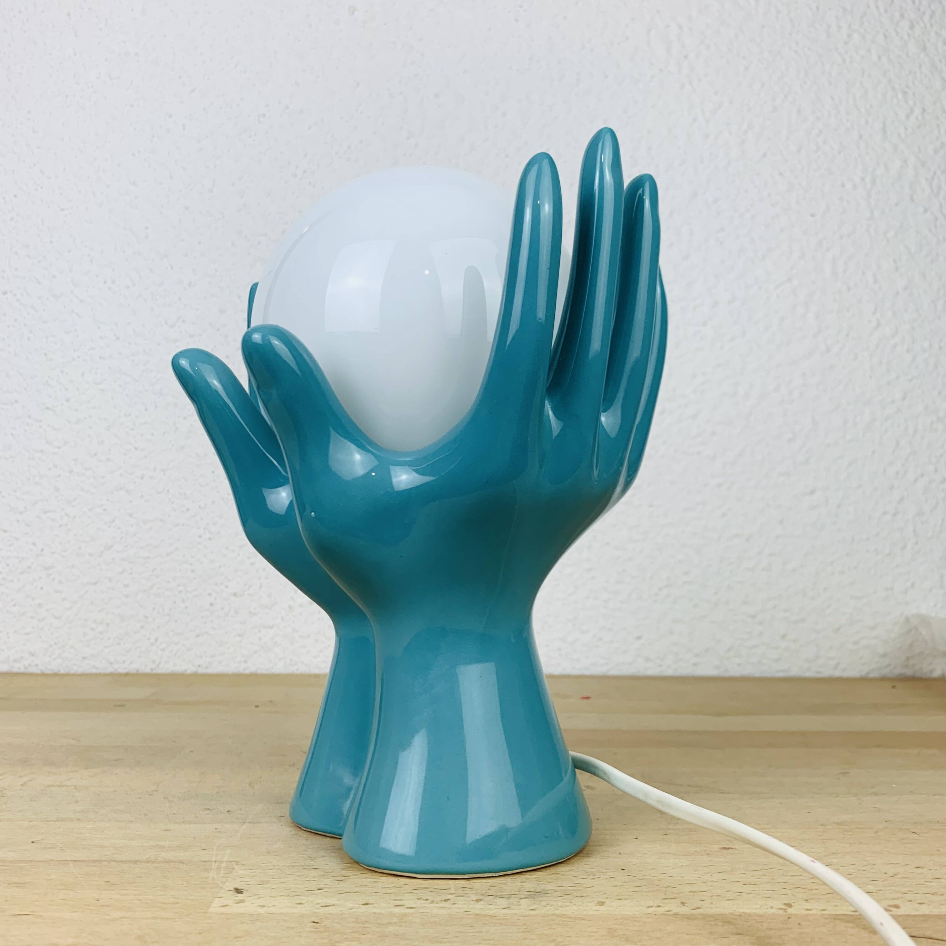 Blue ceramic hands lamp and glass globe