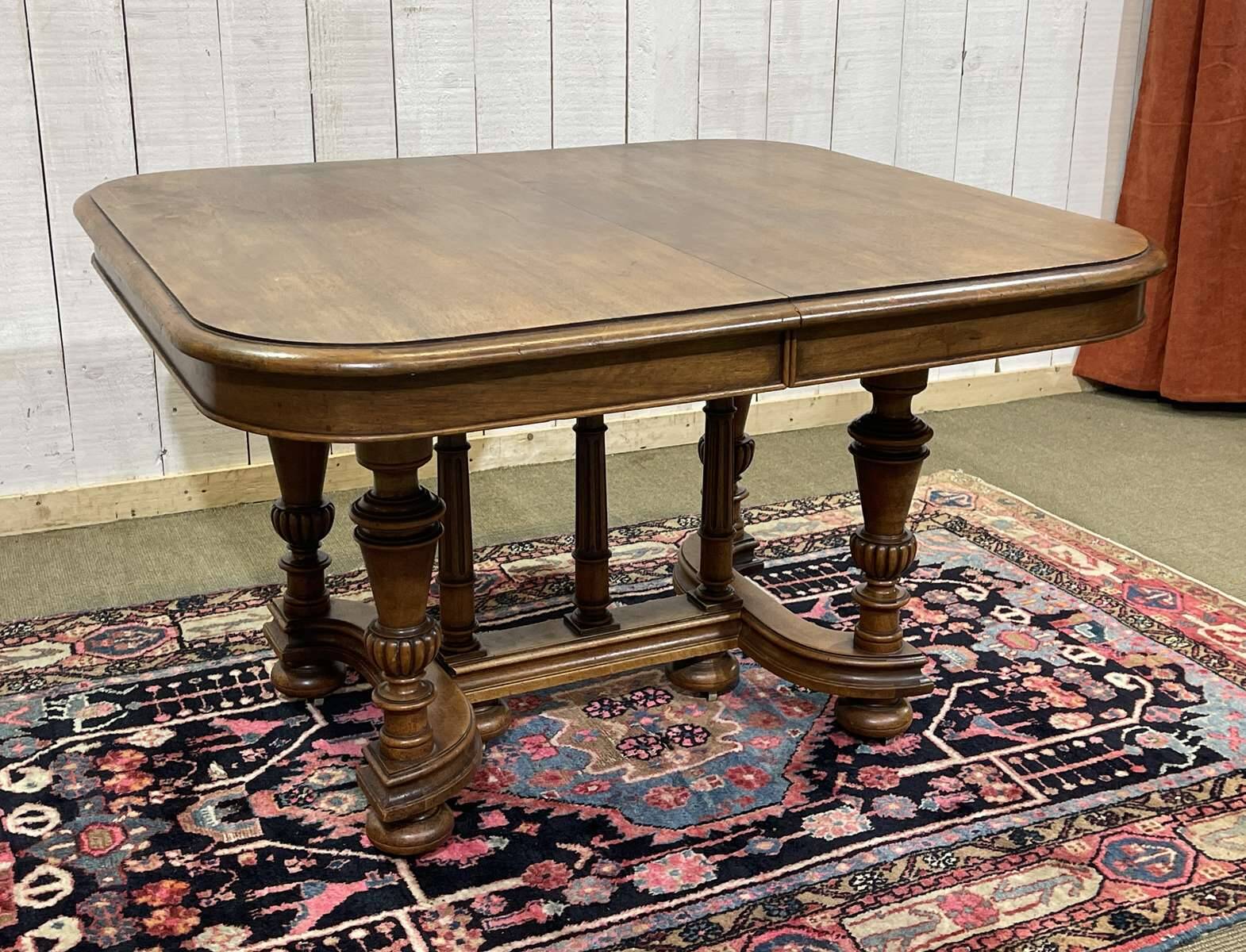 Henri II walnut table from the early 20th century with extensions.