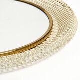 Mid Century Modern round wall mirror with a white expanded metal frame