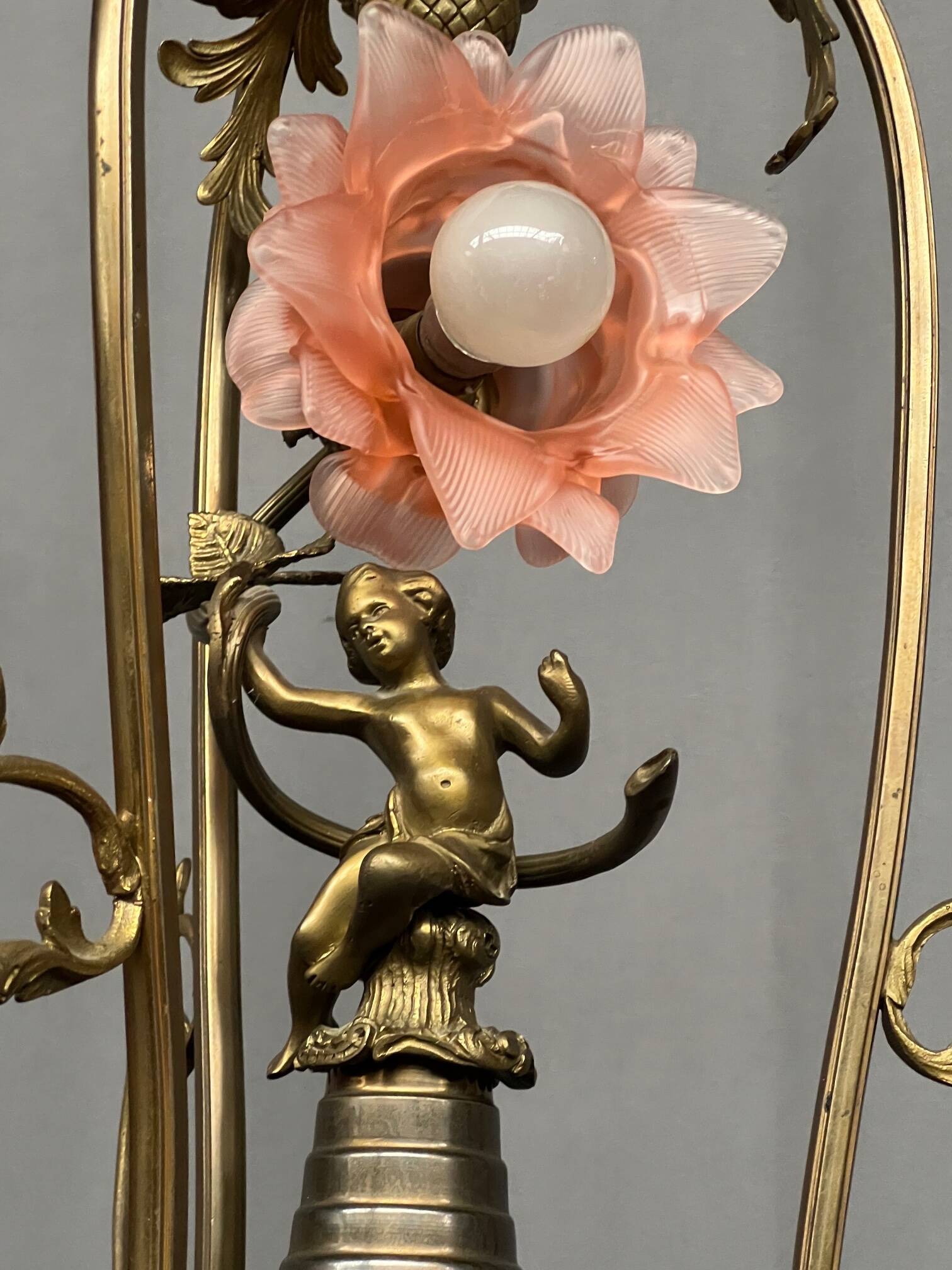 Renaissance chandelier with putti statuette.