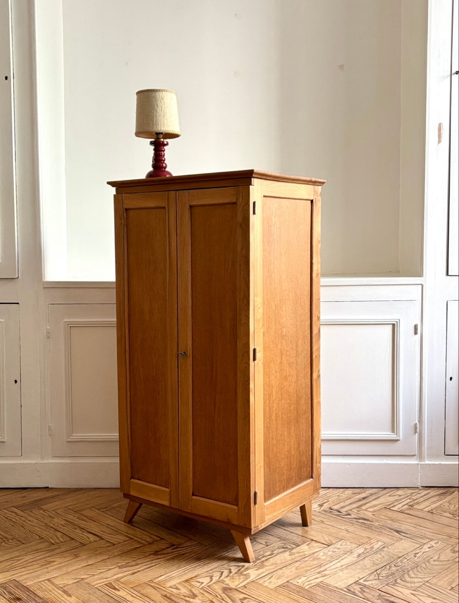 Small oak cabinet with tapered legs.