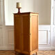 Small oak cabinet with tapered legs.