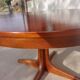 round/oval table with extension, central leg, dark shade, Baumann design