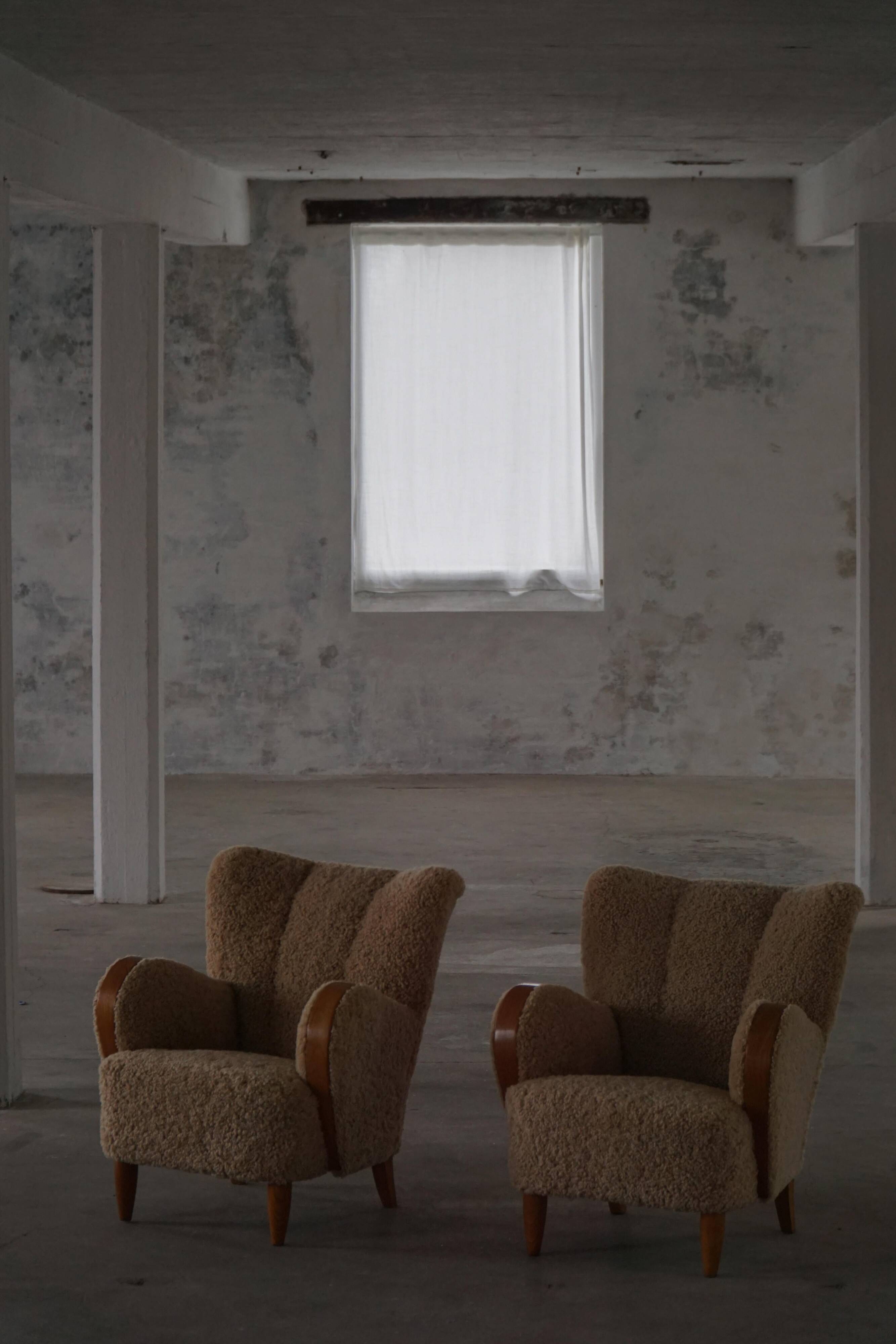 Pair of Danish Art Deco modern lounge chairs in sheepskin with lambswool and elm, 1940s.