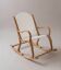 Handcrafted rocking chair in curved wood with a white seat.
