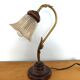 Gold swan neck table lamp with amber tulip glass.