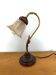 Gold swan neck table lamp with amber tulip glass.
