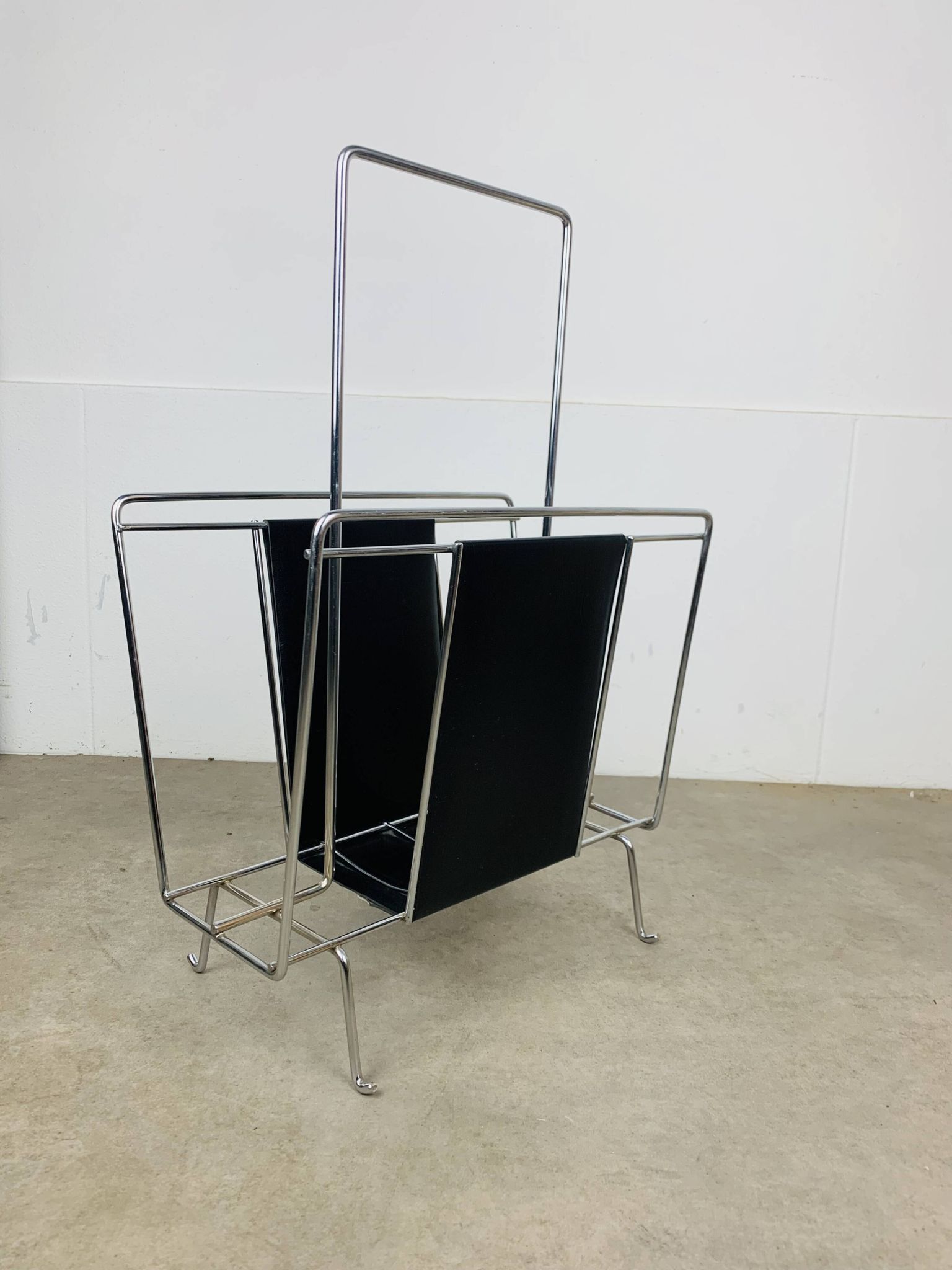 Chrome and black leather magazine rack, 1970s.