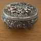 Metal jewelry box inside felt red floral decorations