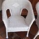 2 white wicker armchairs