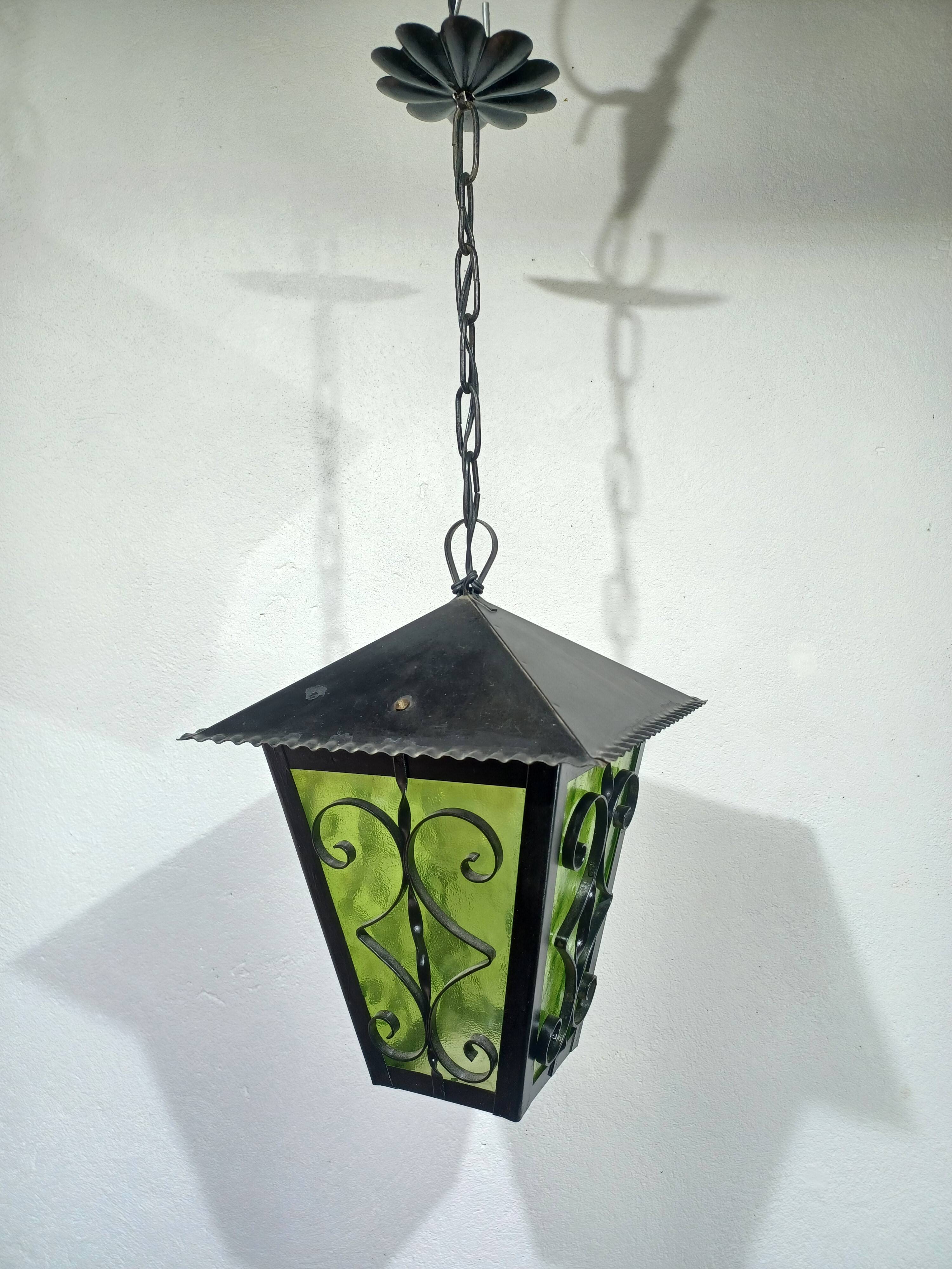 Wrought iron and green glass lantern