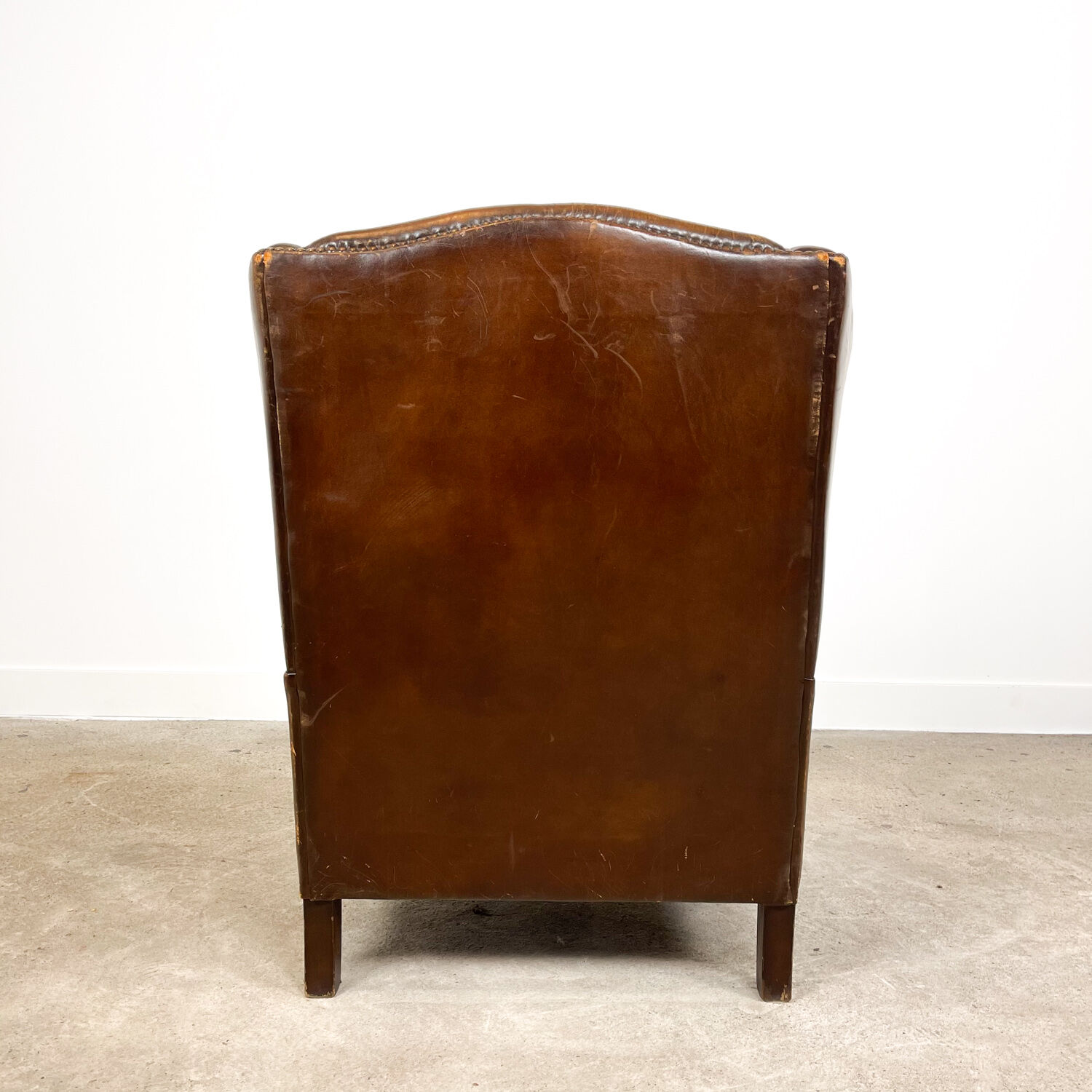 Dark brown sheep leather wingback armchair vintage