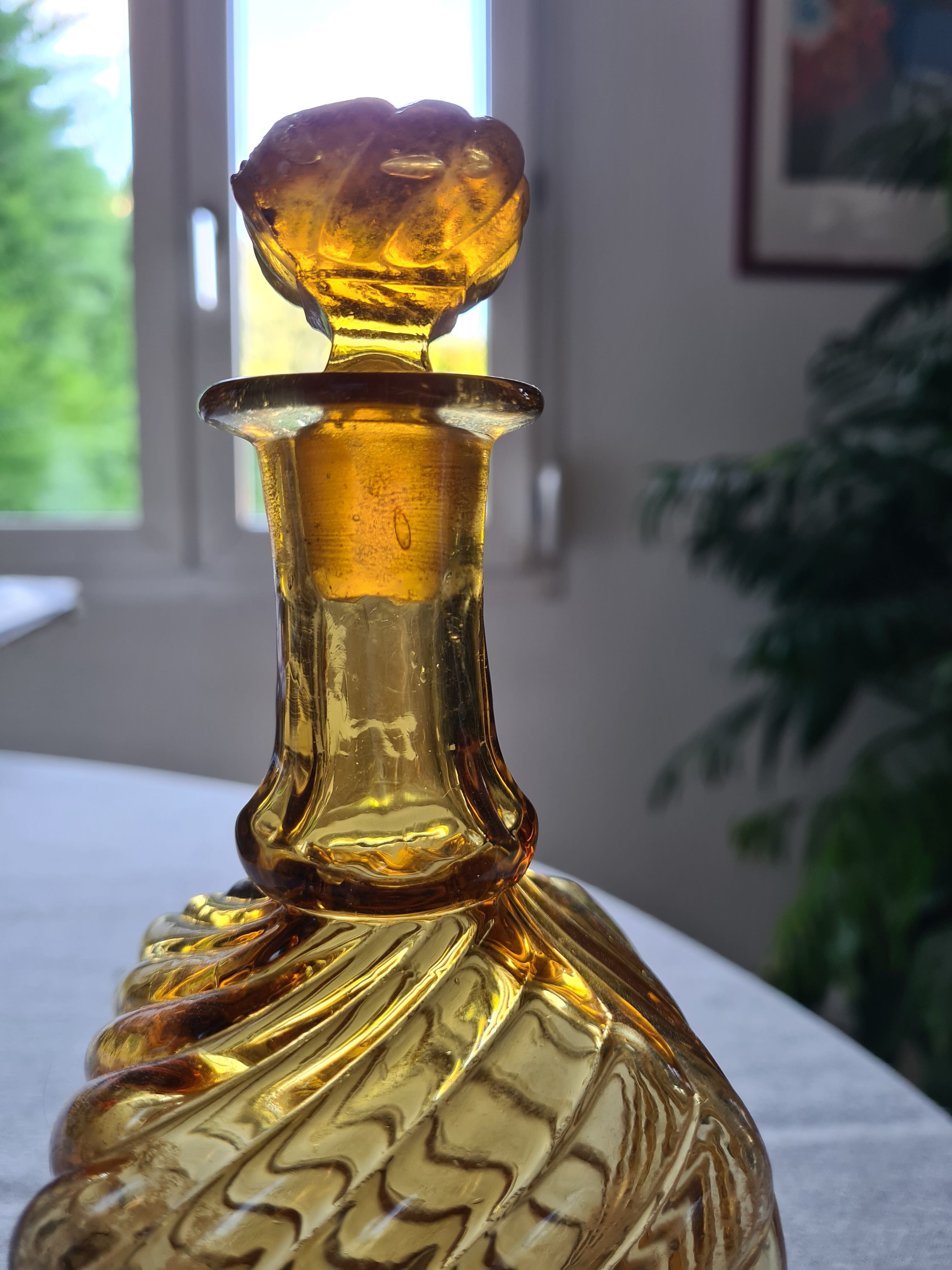 Antique decanter made of amber blown glass