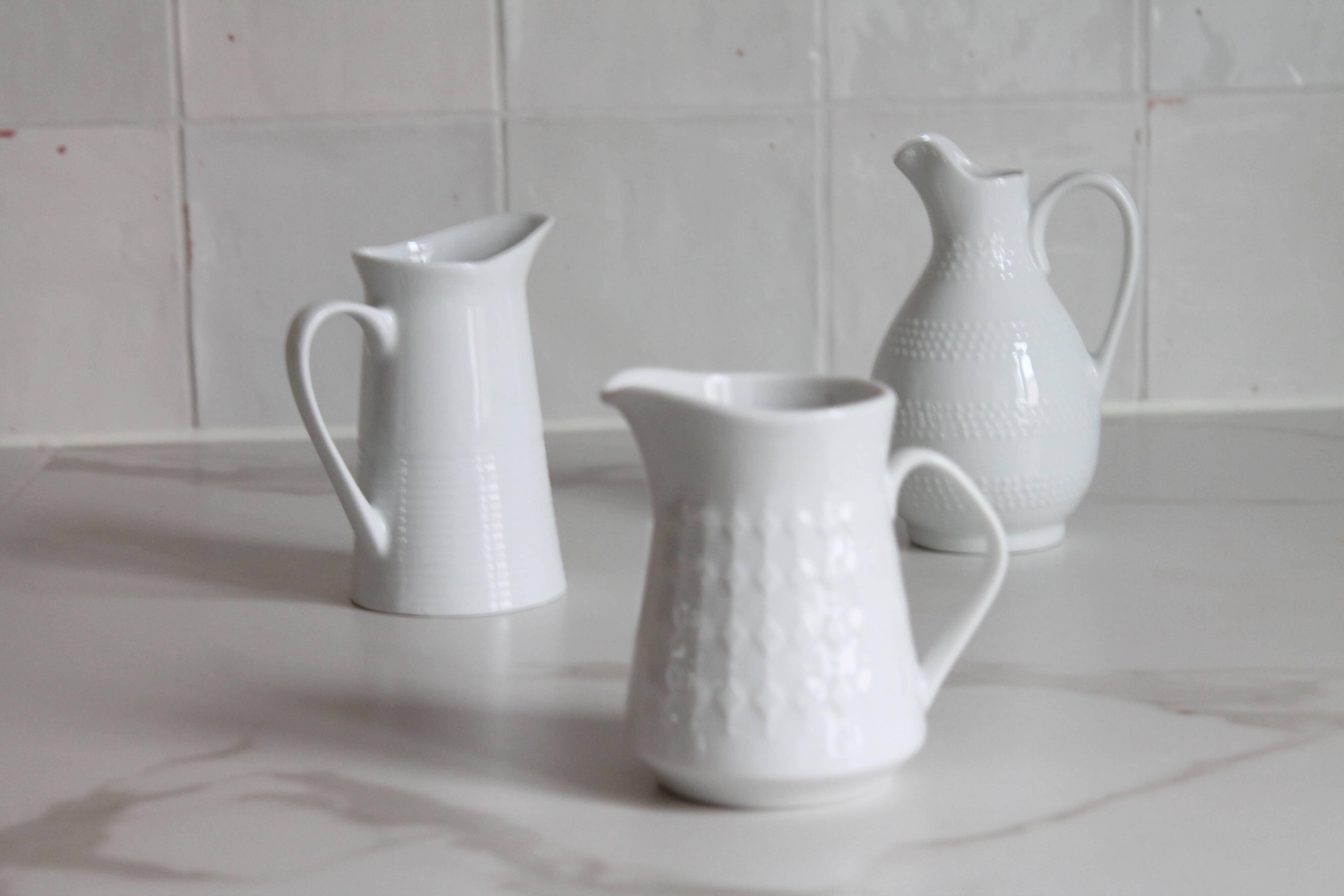 3 old French pitchers in white ceramic