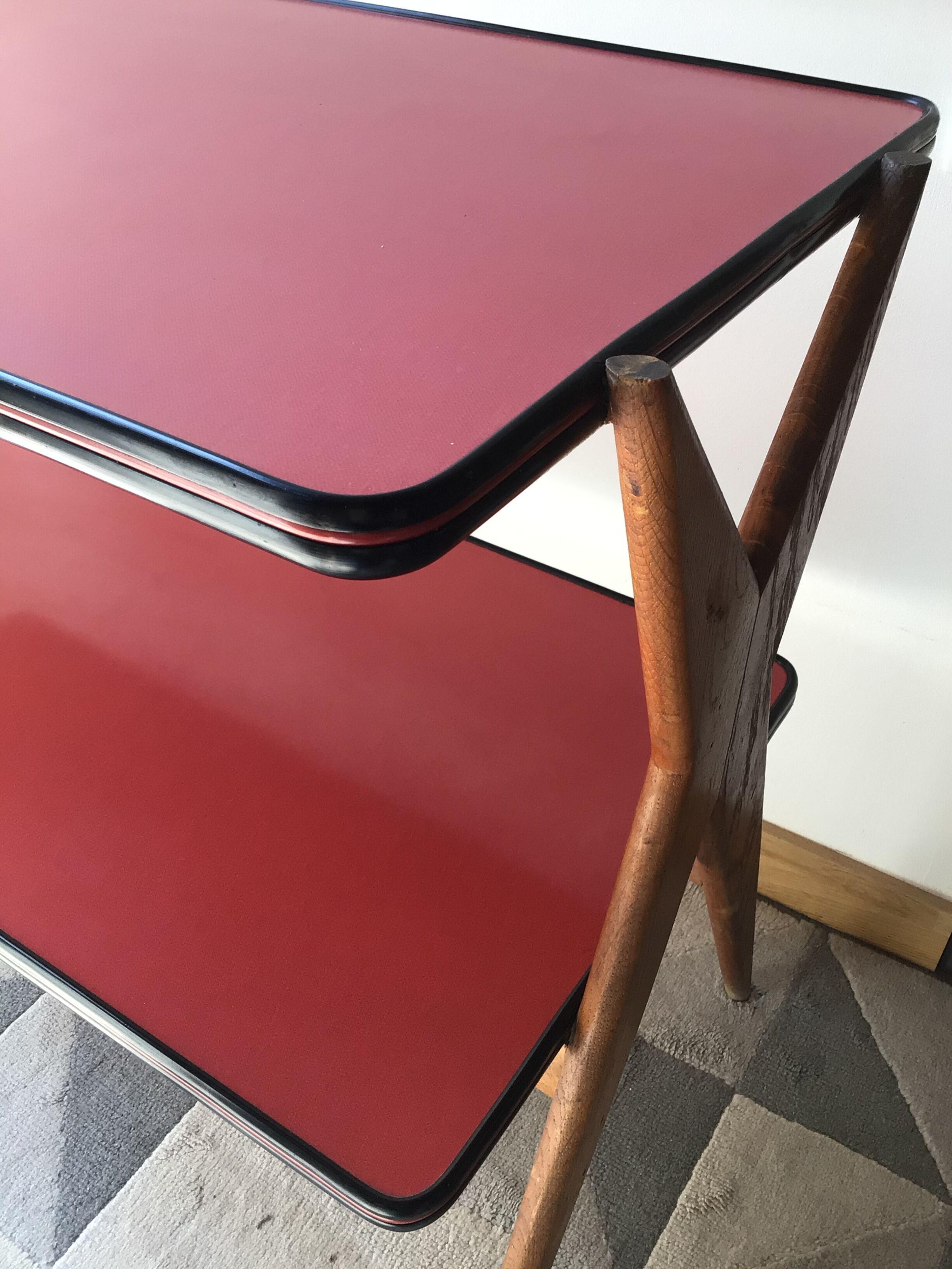Double-footed red Formica wood spindles console