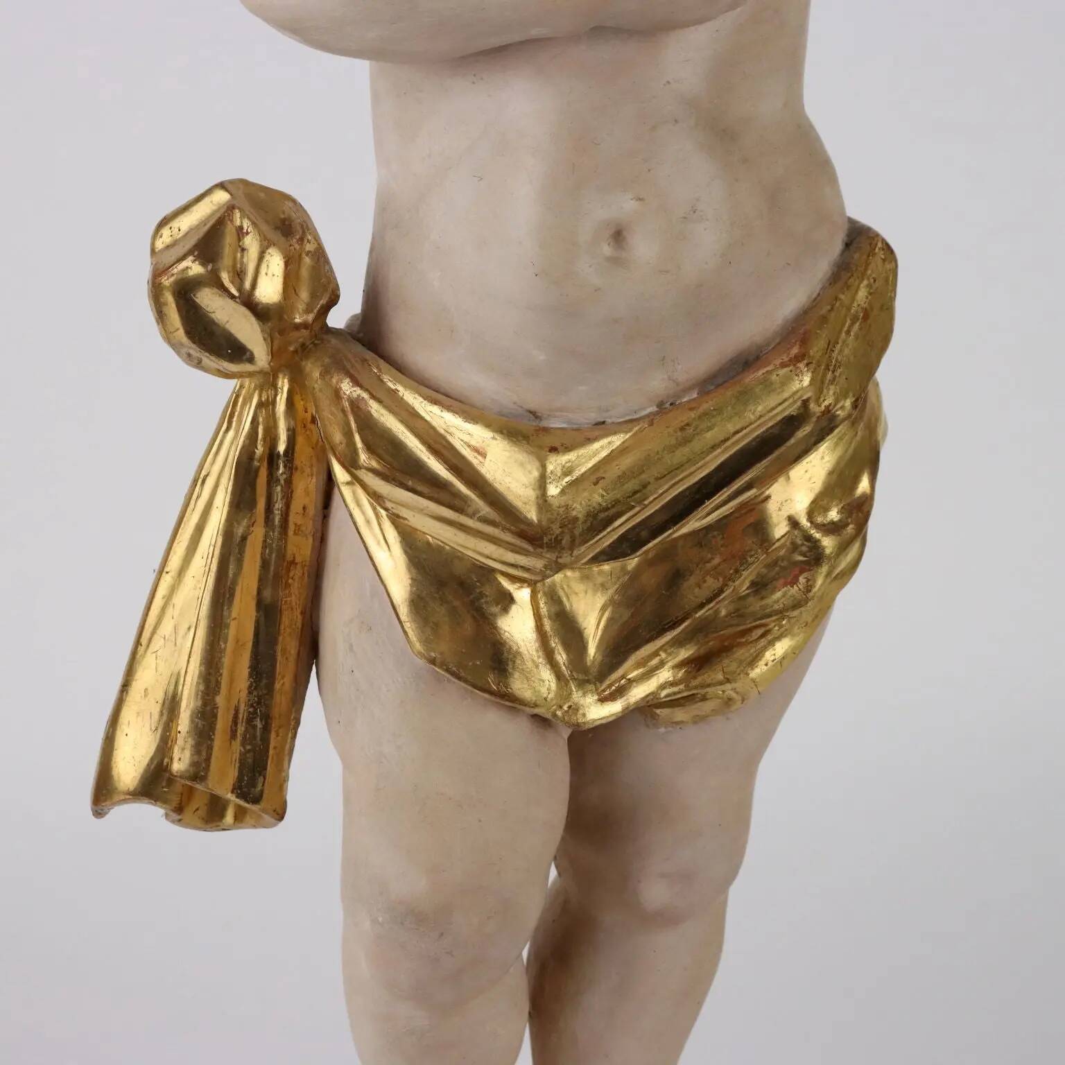 Ancient sculpture of a putto in carved and gilded wood, Italy, 19th century.