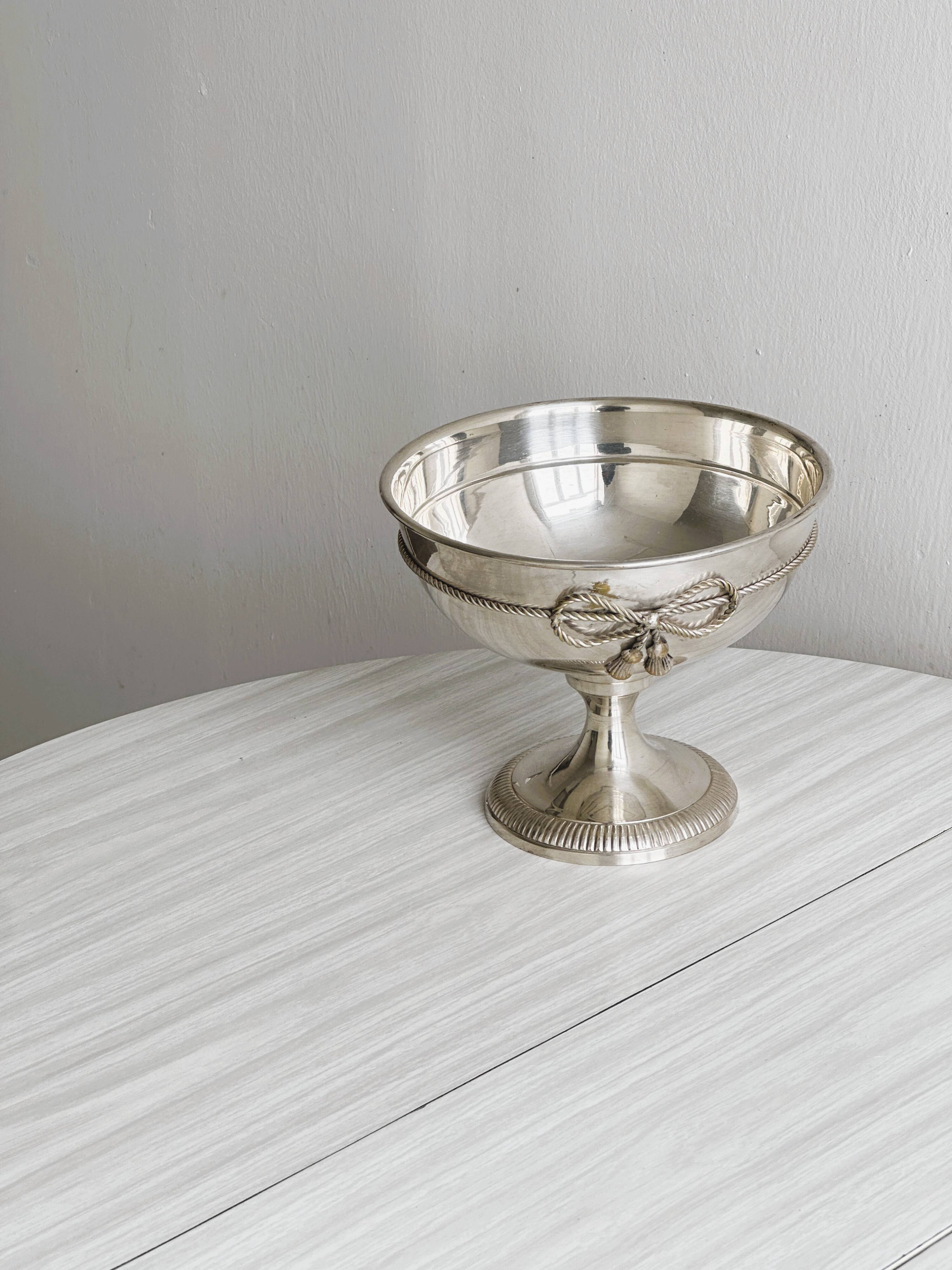 shiny silver metal cup on foot